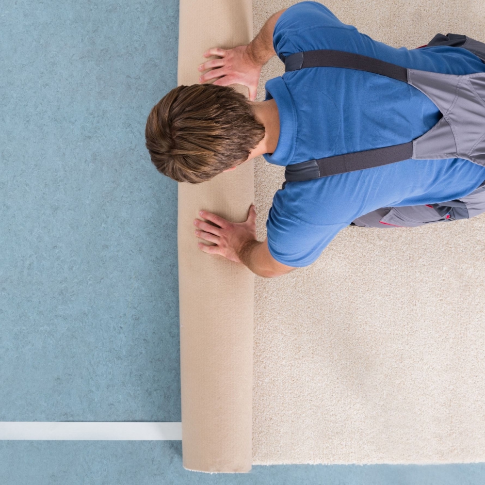 Carpet fitter installing a carpet