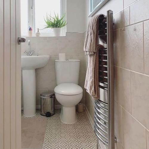 updated bathroom tiles that compliment the Cement Topaz vinyl flooring.