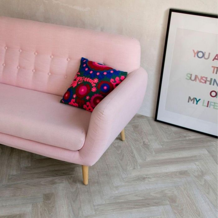 berry alloc java light grey parquet laminate flooring in living room with pink couch and black photo frame