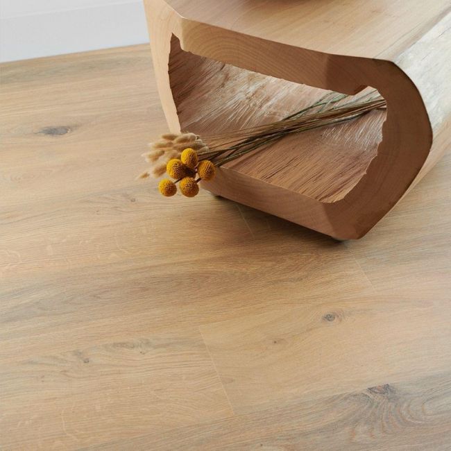 medium oak laminate flooring planks in 8mm thickness with 4v bevelled edges in hallway with flowers gyant natural