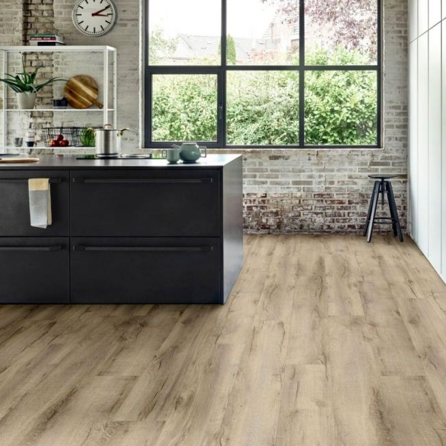 moduleo layred mountain oak 56238 medium wood effect lvt in kitchen with dark units and brick walls