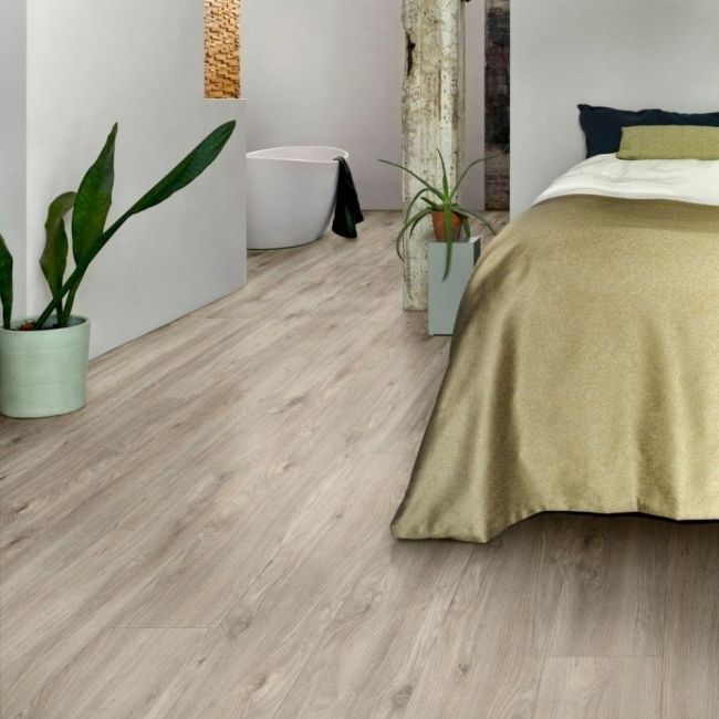 grey wood effect click vinyl flooring in bedrooms with white walls and gold bedding layred sierra oak 58239