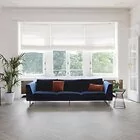 grey wood effect parquet laminate flooring in 8mm thickness with bevelled edges for living room with blue couch and white walls
